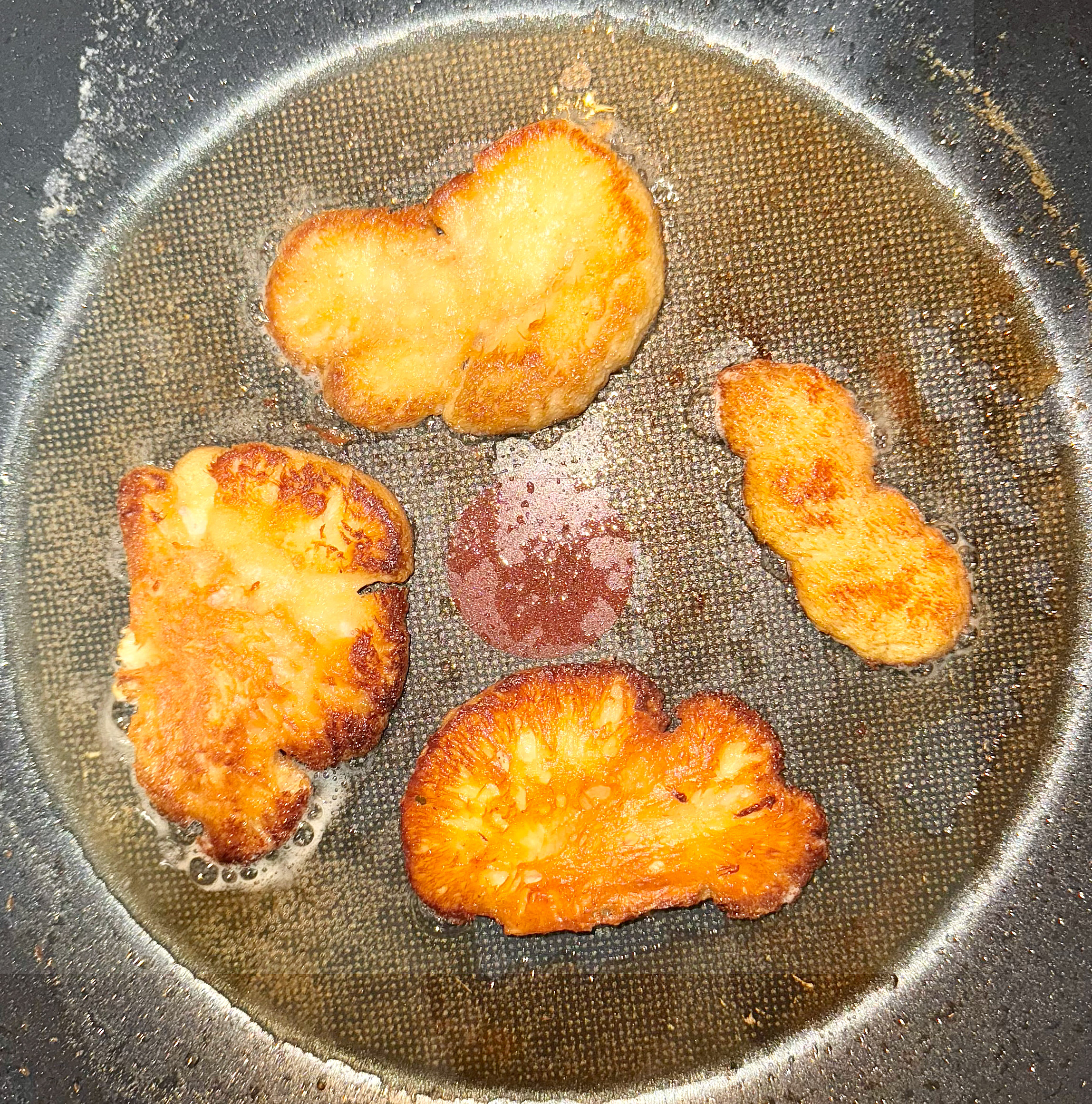 Lion’s mane steaks searing to golden brown
